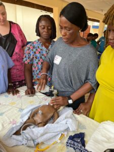 Midwife Aminata Kabba practices ventilation, a very important skill in resuscitating a newborn.
