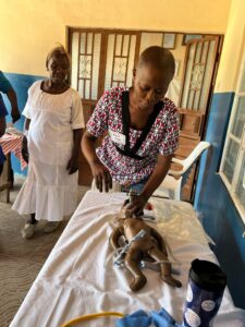 RHCI nurse Maria Songa practices bag/mask ventilation on the Neonatalie doll