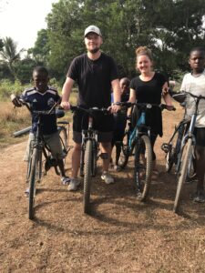 Nick and Riley biking in Tikonko, Sierra Leone