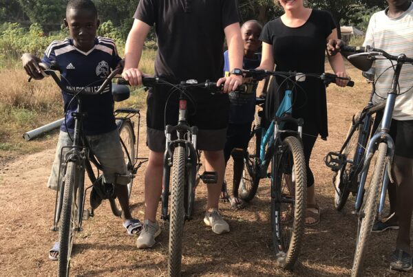 Nick and Riley biking in Tikonko, Sierra Leone