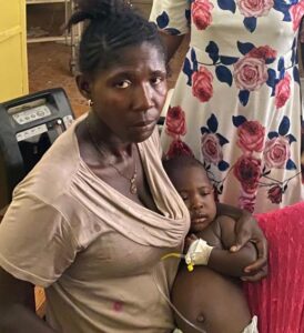 Mother holding baby with Malaria